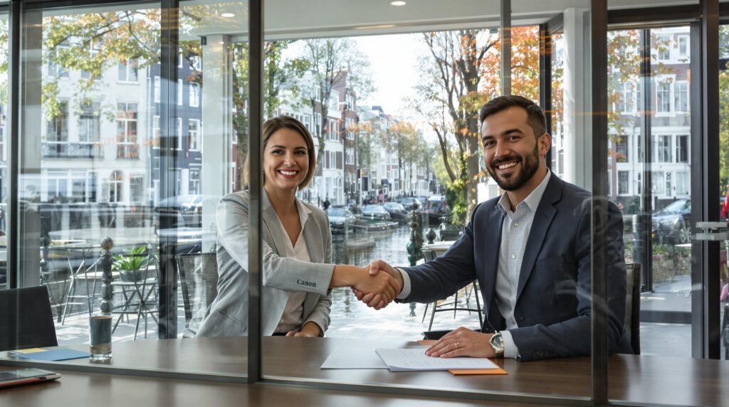 Professionals shaking hands after contract signing in Amsterdam office