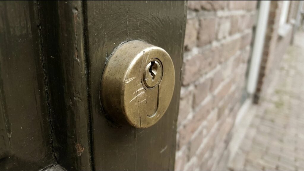 Front door lock with scratch marks around the keyhole
