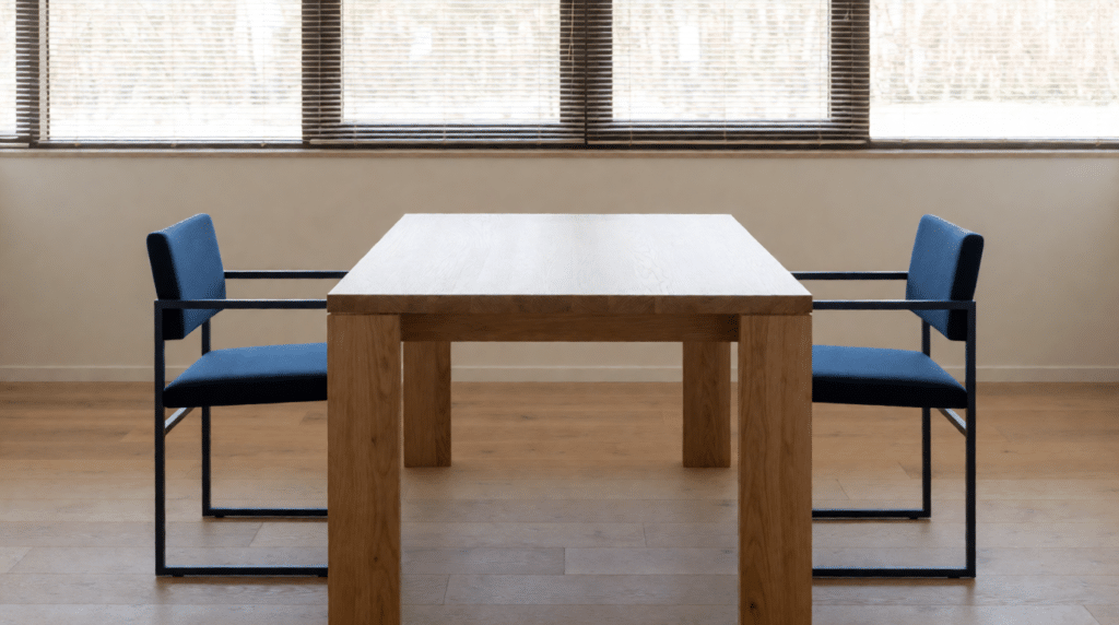 Empty plain room with a table, two chairs and striped blind light
