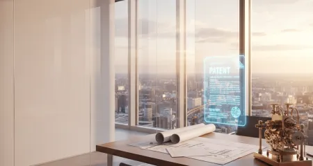Modern office at golden hour with technical blueprints, a patent document, and a brass prototype on a sleek desk, overlooking a city skyline