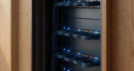 Server room with an open rack door and bundled network cables