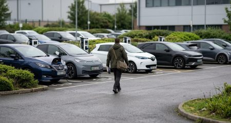 Electric cars charging at a company car park on an overcast day