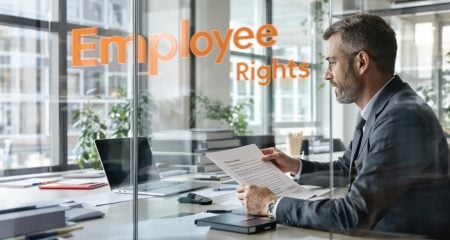 Dutch lawyer and client reviewing employment contract focused on employee rights